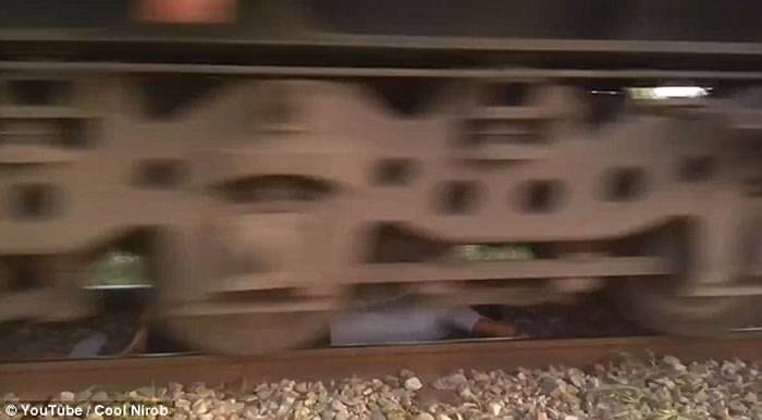 孟加拉国男子玩命伏到路轨上任由高速驶至的火车在头上掠过
