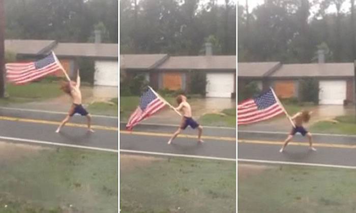 飓风“马修”肆虐 美国佛罗里达州男子挥国旗揈水发